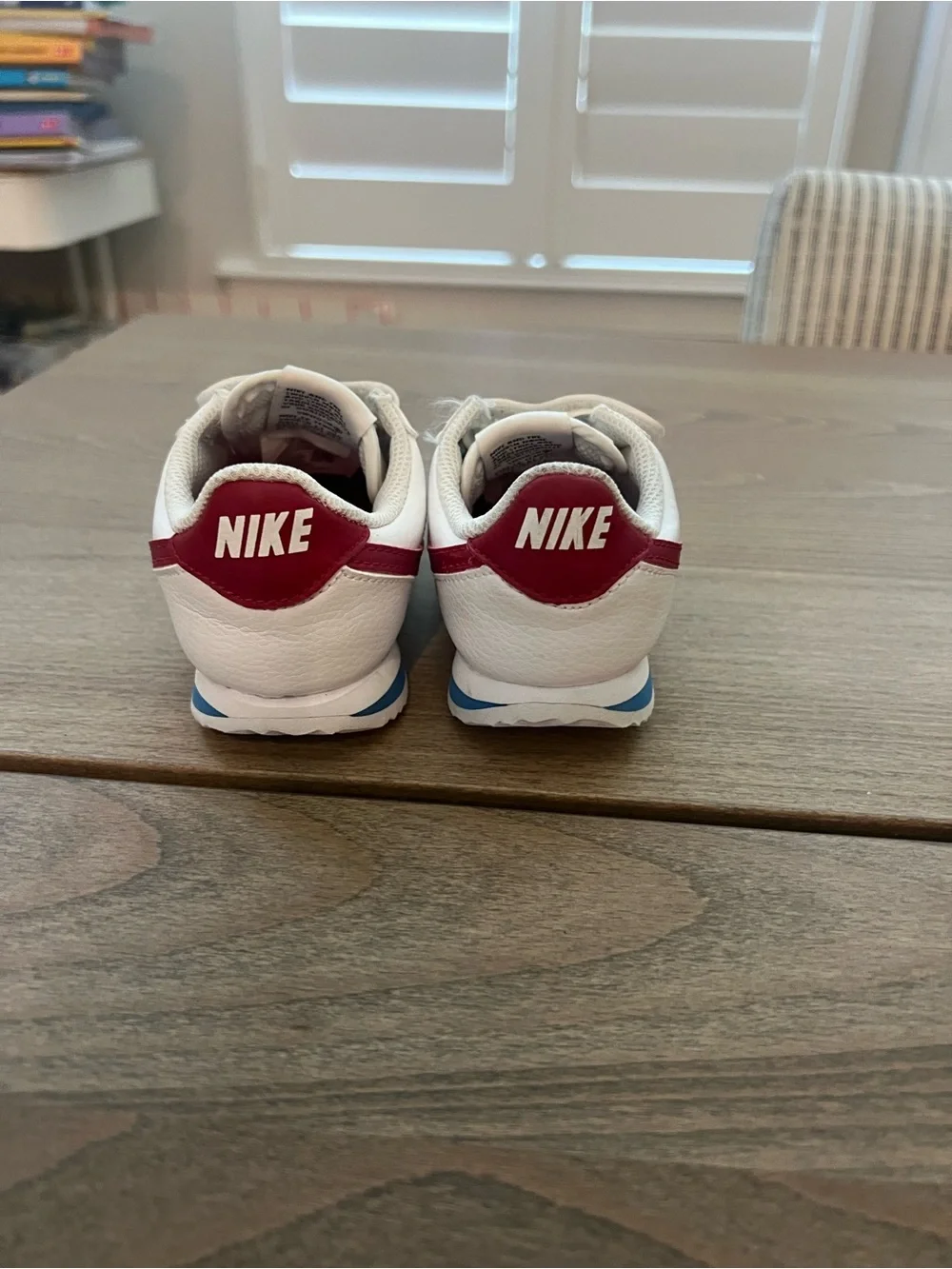 Nike Kids White Sneakers with Red Swoosh and Blue Sole Accent